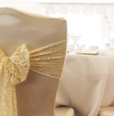 Wedding chairs with cover and gold ribbon