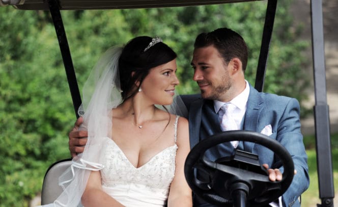 Newly wed couple in golf buggy